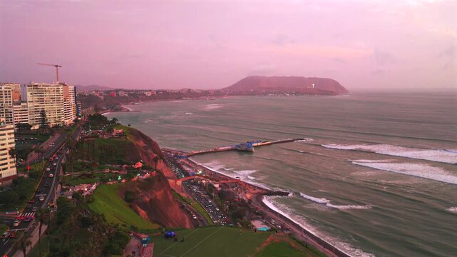 Miraflores Lima Peru Makaha Barranco beach coastal sunset aerial drone harbor view pink purple clear skies Pacific Ocean surfing city skyscraper buildings ocean waves surfing circle right parallax