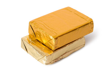 Two processed cheeses in a foil package on a white background. Rectangular curds isolated