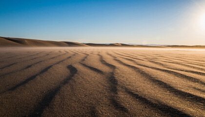 Fototapeta premium Expansive desert landscape with sand dunes and wind ripples under clear sky.