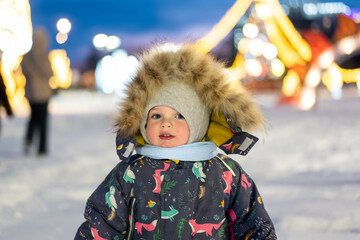 A cheerful young boy playing outside on New Year&rsquo;s Eve