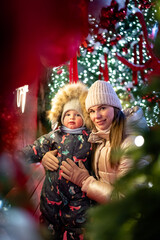 A cheerful mother and son playing outside on New Year&rsquo;s Eve