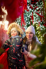 A cheerful mother and son playing outside on New Year&rsquo;s Eve