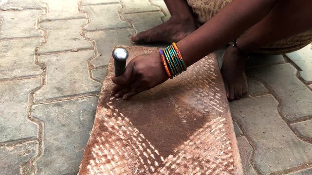 traditional stone grinder | women using a traditional grinding stone | traditional sil batta | worker using chisel and hammer on stone | female worker