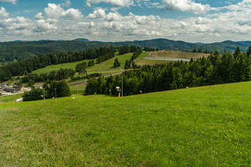 Mountain landscape with green meadows and forested hills in Slotwiny near Krynica Zdroj, Poland