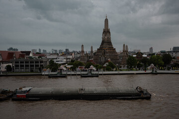 Bangkok, Thailand - June 11, 2025: Evening view of tourists watching the sunset along the Chao Phraya River at Wat Arun.