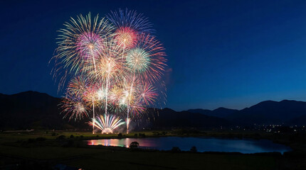 Vibrant fireworks exploding over serene lake at dusk with majestic mountains in background, celebration and festivity concept