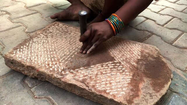 traditional stone grinder | women using a traditional grinding stone | traditional sil batta | worker using chisel and hammer on stone | female worker