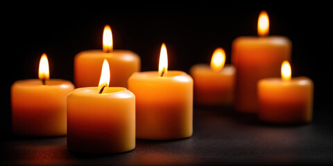 Warm candle flame orange candle wax candle group of candle burning candle dark background soft glow closeup low light