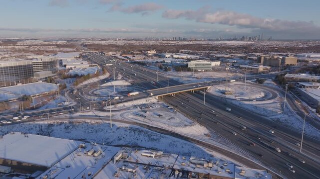Aerial view of snowy HWY 401 with Mississauga skyline in background