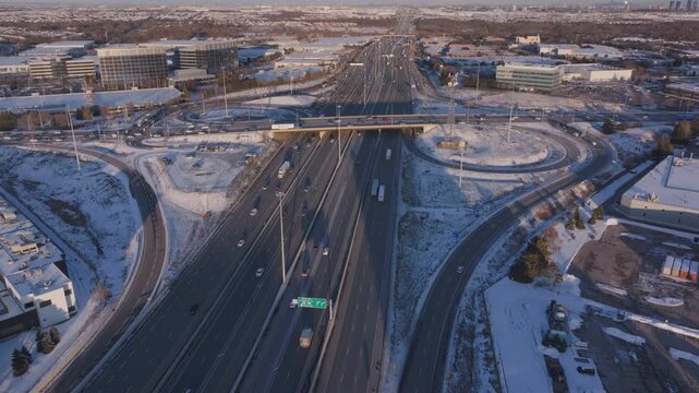 Aerial view of Highway 401 in winter, showcasing traffic and urban landscape