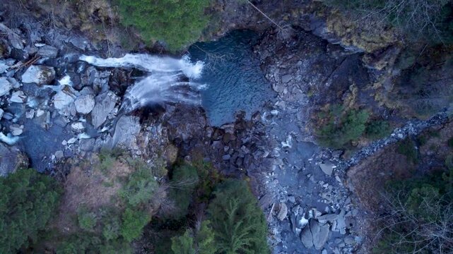 Zenithal view of a waterfall in Switzerland, Champery. Approaching slowly to focus on the water flowing.