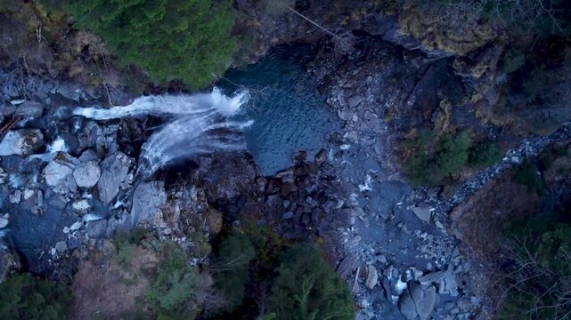 Zenithal view of a waterfall in Champery, Switzerland. Winter season in the evening.