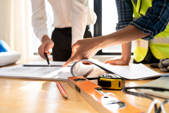 Engineers team and owner discuss check and review the blueprint of construction. Contractor inspection drawing before start project civil. project planning, consulting, architecture.