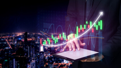 A businessman uses a tablet to analyze financial data with a digital interface, set against a stunning city skyline at night, symbolizing growth and success. Impute