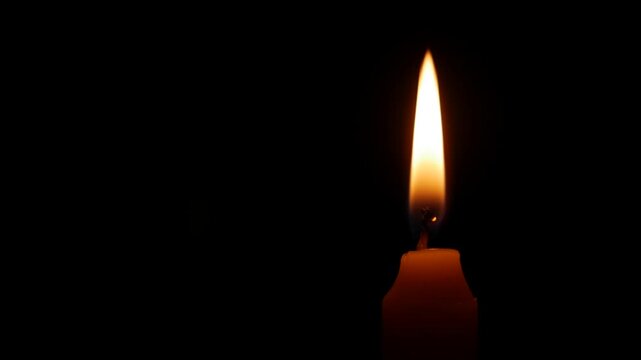 A calm candle flame drifts gently in open black space suggesting sorrow remembrance and the persistent weight of memory felt during reflective silence. Grief tribute.