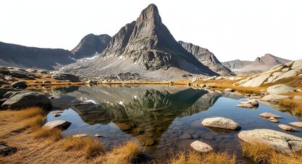 Alpine Mountain Reflection. A stunning landscape featuring a jagged, steep mountain peak rising behind a calm, clear alpine lake. The mountain's reflection is perfectly mirrored in the water's surface