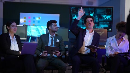 Corporate technology meeting in a modern office. Strategic team analyzing software code and market data displayed on large monitoring screens. Professionals discussing digital transformation and IT so - Powered by Adobe