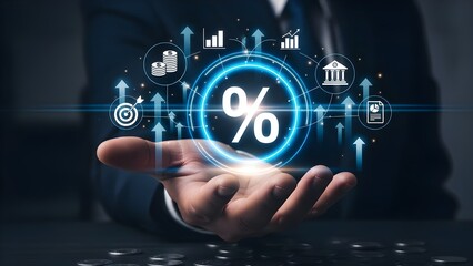 Close-up of a businessman's hand with a glowing blue percentage sign and various financial icons floating above, conveying a modern and technological mood in a dark office setting.