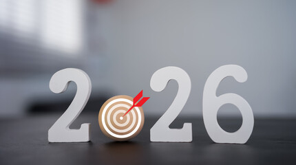  wooden numbers and a target symbol form 2026. Future goals, business strategy, planning, and setting objectives for the new year concept. 

