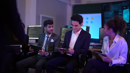 Corporate technology meeting in a modern office. Strategic team analyzing software code and market data displayed on large monitoring screens. Professionals discussing digital transformation and IT so - Powered by Adobe