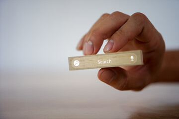 A finger interacting with a virtual search bar, depicting online discovery user intent and the process of information retrieval for smarter decisions.  
