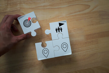 Hand touching and push target board which printing on jigsaw  icon set up business objective target goal concept. Targeting the business concept. 