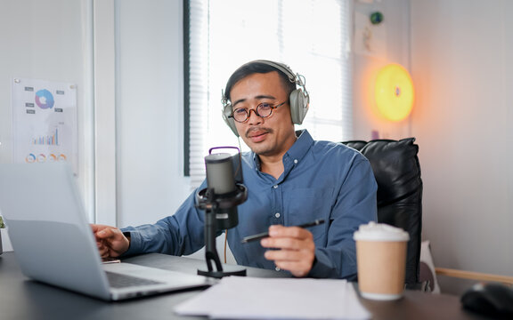 Live streaming, man and happy as radio presenter with microphone, talk show or entertainment. Male person, content creator and podcast host in studio for recording audio or social media on portrait