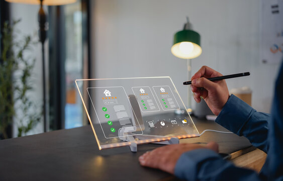 Real estate review rating concept showing businessman using digital pen on laptop to give property five-star rating, smart technology, online service, feedback system, and housing evaluation.