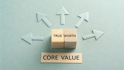 Wooden blocks showcasing true worth and core value with arrows representing direction and growth in a business context