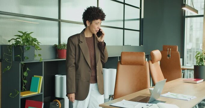 black project manager planning strategy on phone at desk