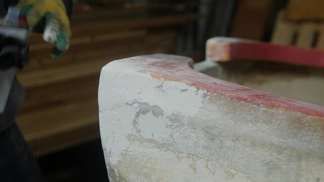Wiping down sanded fiberglass boat with acetone