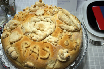 Signs of Serbian orthodox religious glory: candle, grain, Slavic cake, wine, icon of St. Nicholas