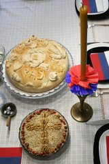 Signs of Serbian orthodox religious glory: candle, grain, Slavic cake, wine, icon of St. Nicholas