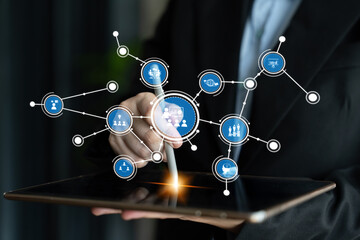 A professional hand interacts with a visual digital network on a tablet, showcasing modern technology and connectivity in a dynamic business environment. Tessel