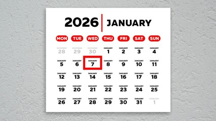 The date January 7th marked with a red cursor on the wall calendar 2026