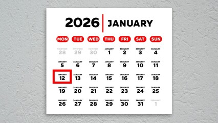 The date January 12th marked with a red cursor on the wall calendar 2026