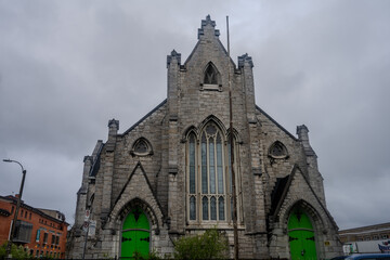 Fototapeta premium Gothic stone church with bright green doors in Kingston
