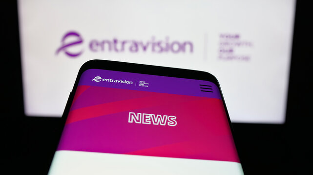Stuttgart, Germany - 12-11-2025: Mobile phone with website of US company Entravision Communications Corp. on screen in front of logo. Focus on top-left of phone display.