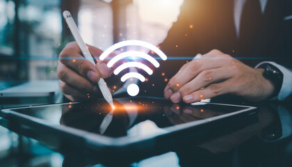 Business professional using tablet with glowing WiFi symbol overlay.
