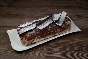 Tiramisu Tronchetto Dessert, Italian Yule Log Christmas dessert with chocolate bark, High quality photo