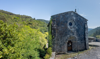 Ancient Stone Chapel Amidst Lush Greenery