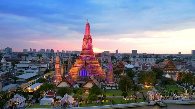 Orbit around illuminated Wat Arun Temple at Night