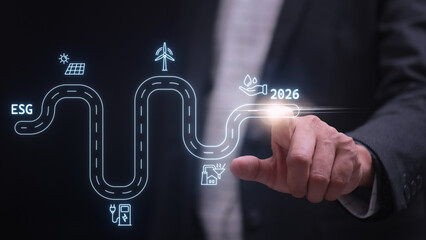 Confident businessman touching future esg roadmap graphic virtual screen for 2026 sustainability strategy goal