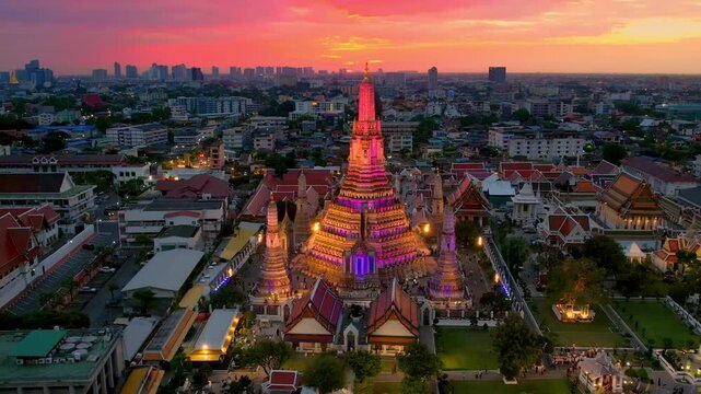 Move past Illuminated Wat Arun Temple at sunset