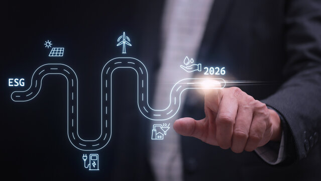 Confident businessman touching future esg roadmap graphic virtual screen for 2026 sustainability strategy goal - Powered by Adobe