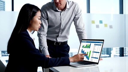 Diverse business professionals analyzing financial data on a laptop in a modern office meeting. Collaboration, teamwork, strategy, and successful business growth. - Powered by Adobe