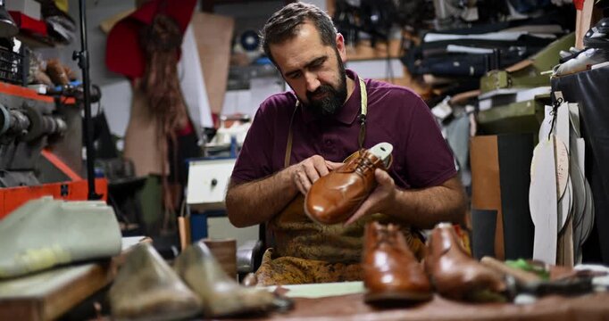 Experienced Shoemaker Meticulously Inspects a Handcrafted Leather Shoe in His Traditional Workshop, Showcasing Dedication to Quality