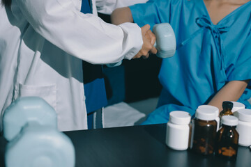 Physical therapist assisting a woman with dumbbell exercise