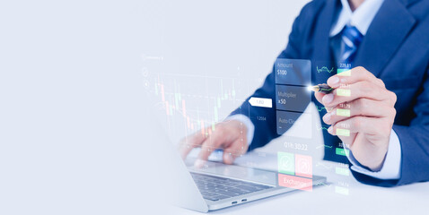 Businessman using laptop and stylus pen with virtual trading dashboard, financial market analysis, investment strategy, stock exchange data, fintech technology and online trading concept.