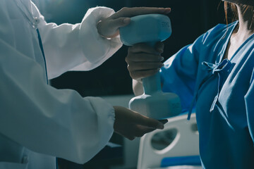 Physical therapist assisting a woman with dumbbell exercise